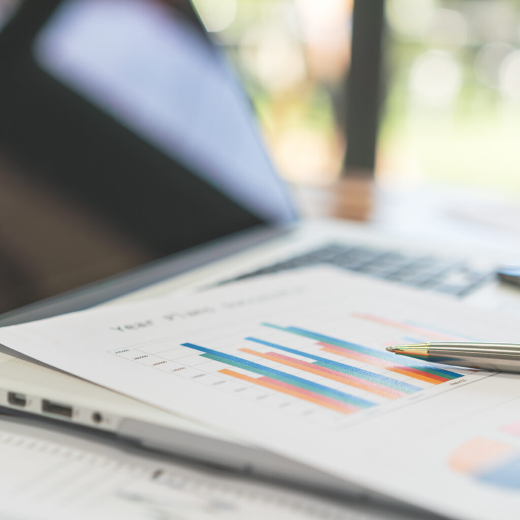 financial charts on the table with laptop . ( filtered image pr